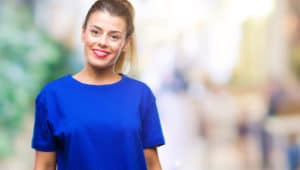 young woman in blue shirt with beautiful smile