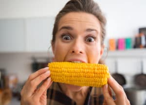 woman eating corn
