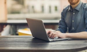 man at table on laptop