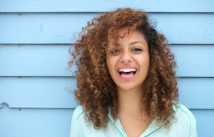 Young woman smiles after receiving periodontal treatments in Austin, TX