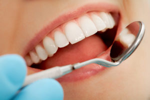 close up of dentist looking in patients mouth