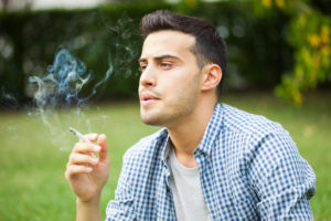 man smoking in park