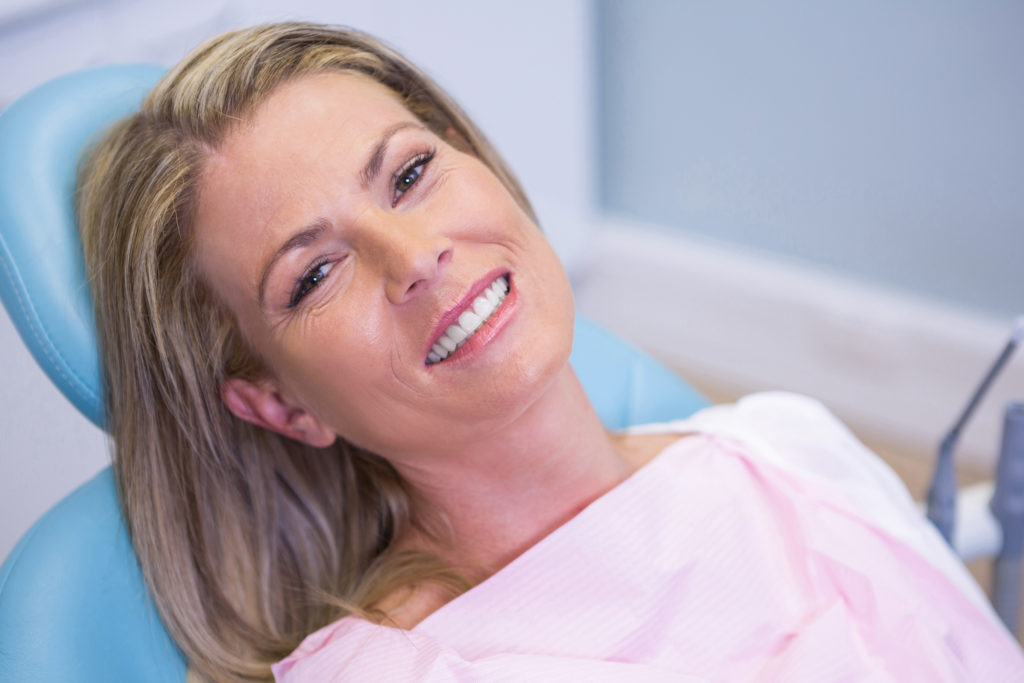 woman smiling in dentist's chair