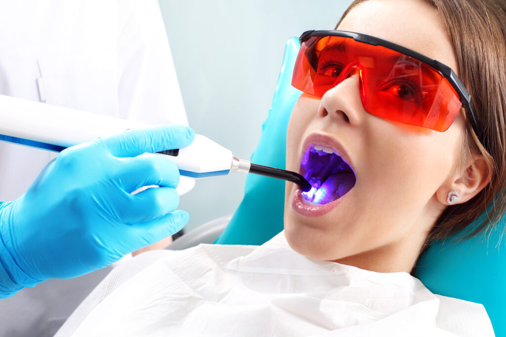 Woman getting laser dental treatment