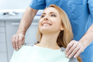 young blonde woman smiling in restorative dentistry chair