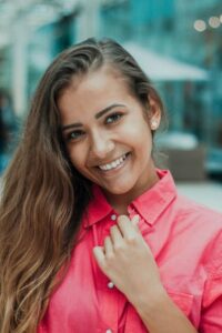 woman smiling in pink shirt