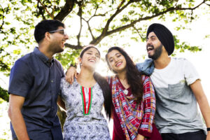 A group of four people smile at each other after receiving modern dentistry in Austin, TX