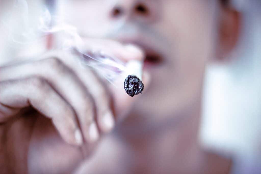 close up of man smoking cigarette