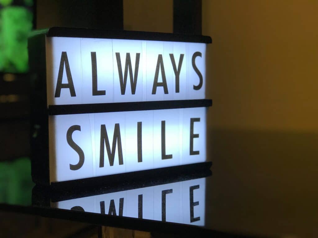 sign that says "always smile"