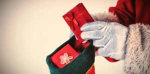 close up of Santa placing gifts into a stocking