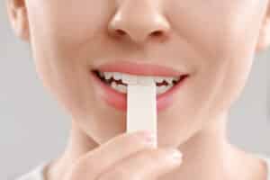 close up of girl placing a piece of gum in her mouth