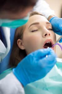 dentist examining patients mouth