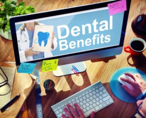 man using computer with "dental benefits" on screen