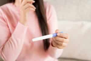 woman holding a pregnancy test